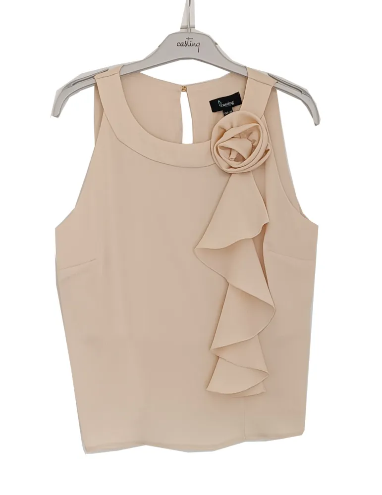 Beige satin sleeveless top with ruffle detail and floral brooch