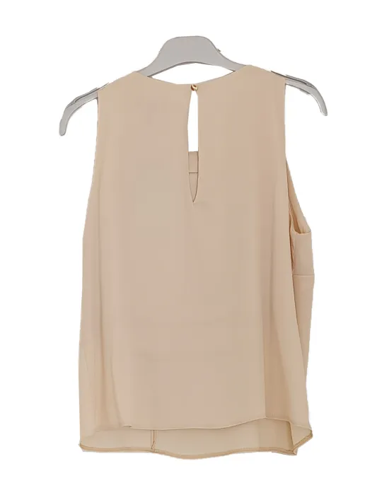 Beige satin sleeveless top with ruffle detail and floral brooch