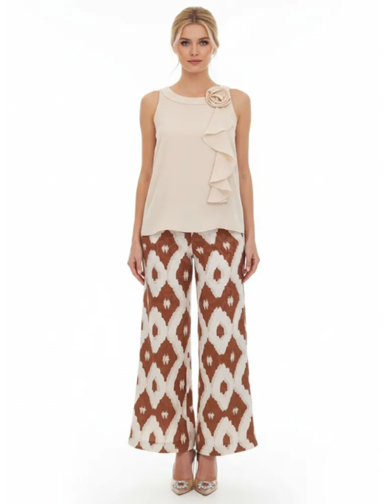 Beige satin sleeveless top with ruffle detail and floral brooch